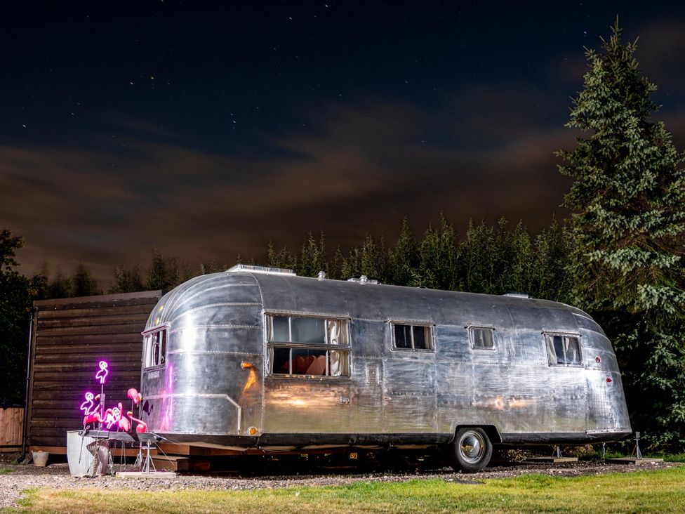 A trailer with neon lights in an outdoor setting at Sleeps 2 - Hot Tub - Pet Friendly - PeggySue
