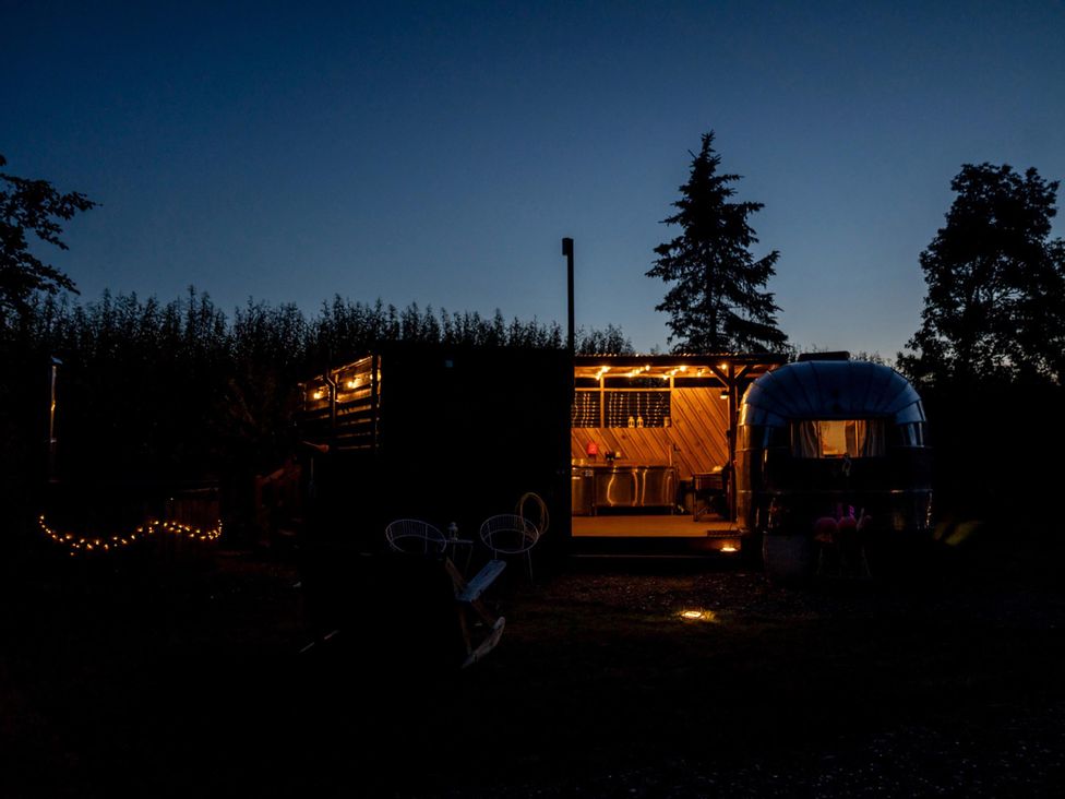 An outdoor view of a structure with lights at Sleeps 2 - Hot Tub - Pet Friendly - PeggySue