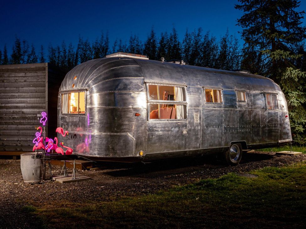 A vintage trailer with flamingo decorations at Sleeps 2 - Hot Tub - Pet Friendly - PeggySue
