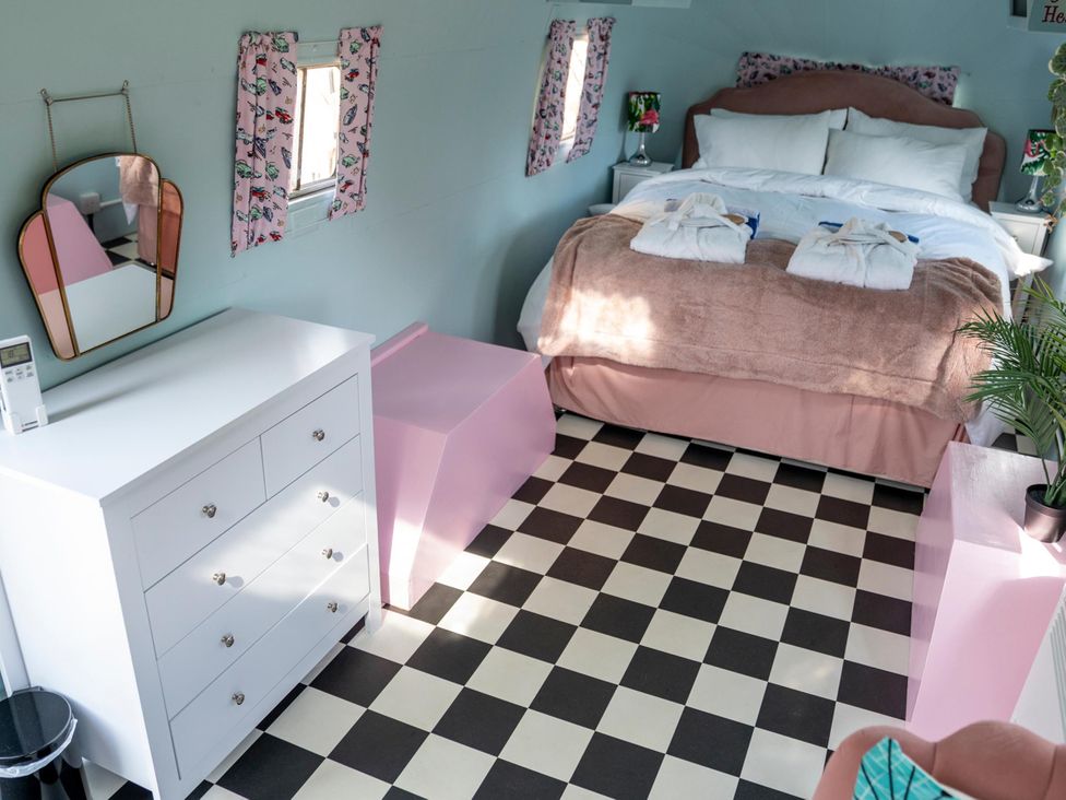 A bedroom with a bed and furniture at Sleeps 2 - Hot Tub - Pet Friendly - PeggySue