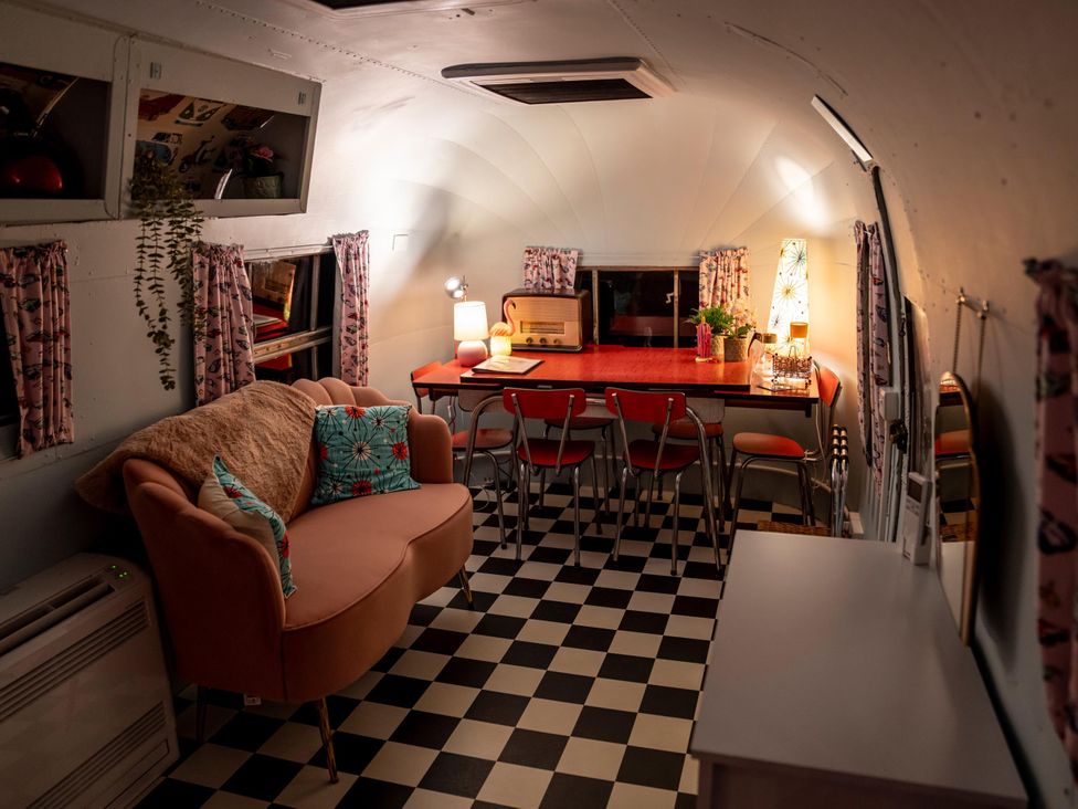 A living room with a sofa and dining area at Sleeps 2 - Hot Tub - Pet Friendly - PeggySue