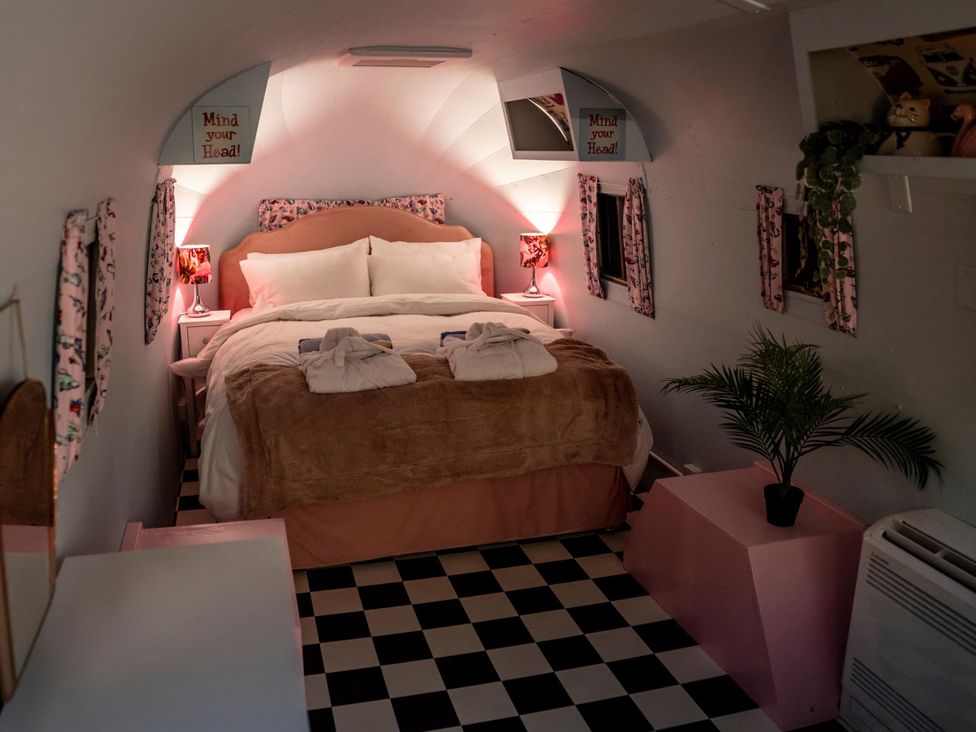A bedroom with a bed and a plant at Sleeps 2 - Hot Tub - Pet Friendly - PeggySue