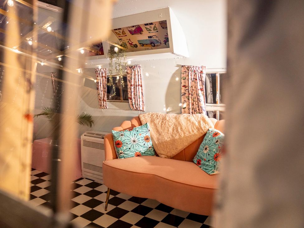 A living room with a sofa and cushions at Sleeps 2 - Hot Tub - Pet Friendly - PeggySue