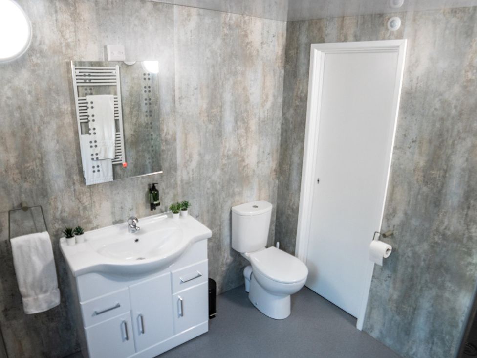 A bathroom with a sink and toilet at Sleeps 2 - Hot Tub - Pet Friendly - PeggySue