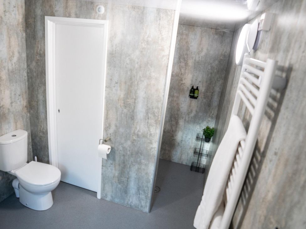 A bathroom with a toilet and shower at Sleeps 2 - Hot Tub - Pet Friendly - PeggySue