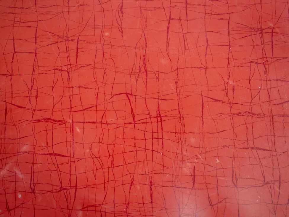 A textured red surface with lines and crack patterns at Sleeps 2 - Hot Tub - Pet Friendly - PeggySue