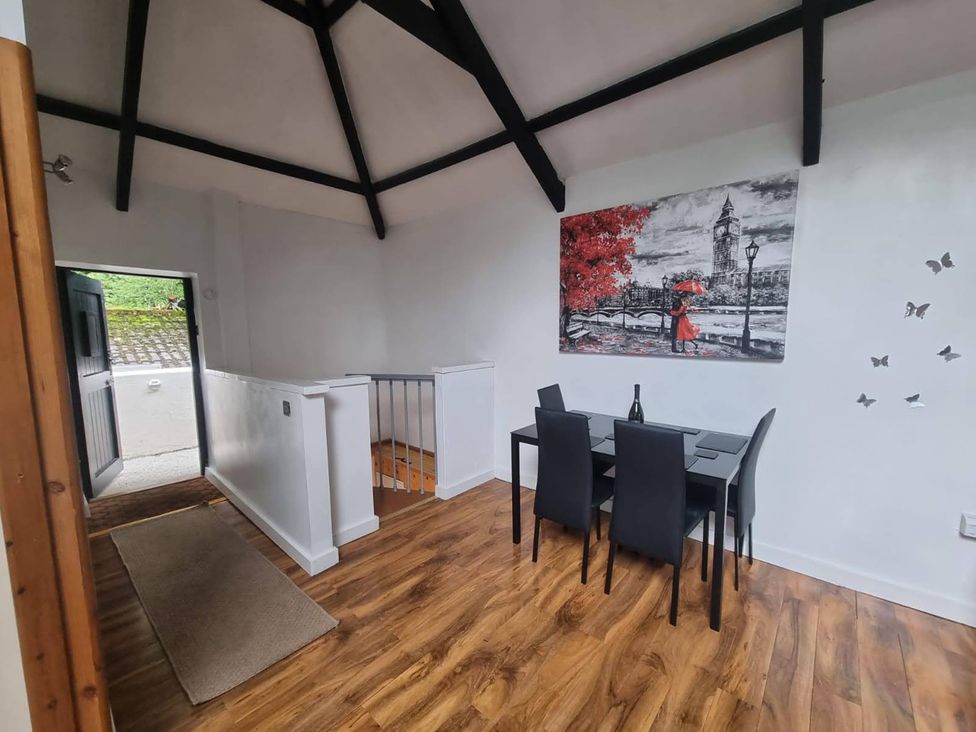 A dining room with a table and chairs featuring wall art at a property
