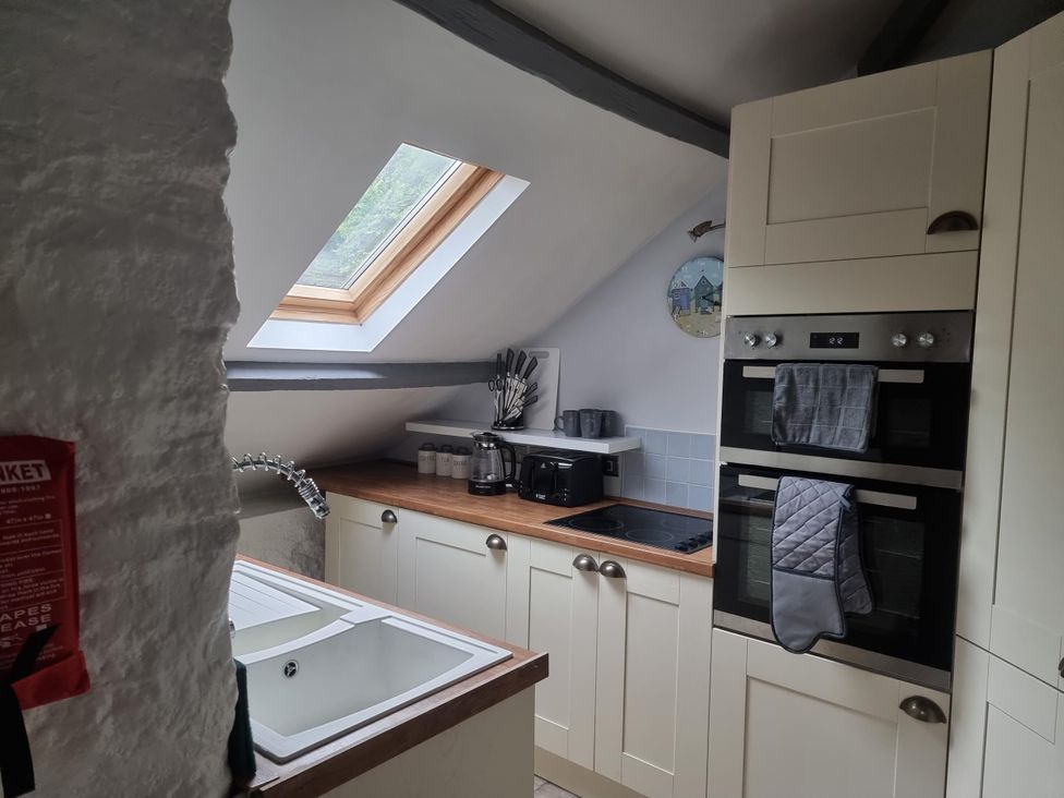 A kitchen with a sink, countertop, and oven at The Old Barn in Manchester