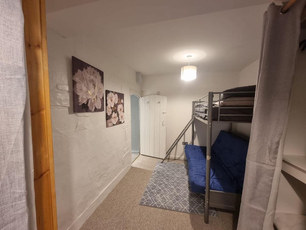 A bedroom with a bunk bed and a sofa bed at 