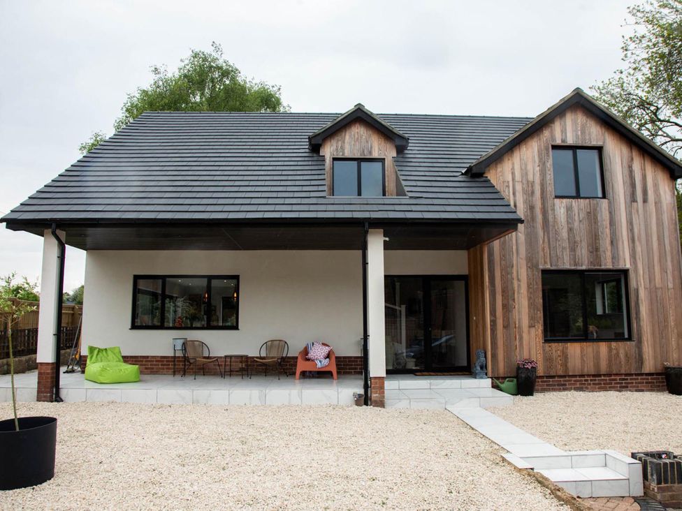 A house with a roof and windows at House Sleeps 10 with Enclosed Garden
