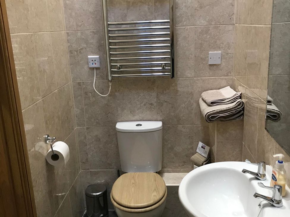 A bathroom with a toilet and sink at The Old Barn in Manchester