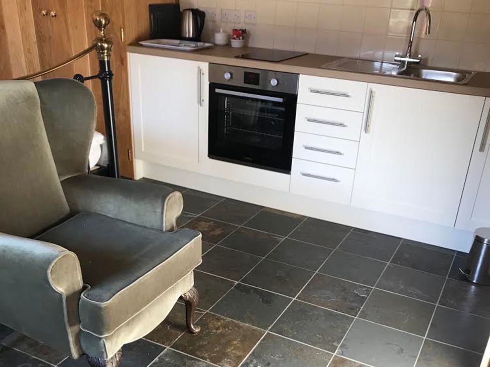 A kitchen with an oven and cabinets at the property location