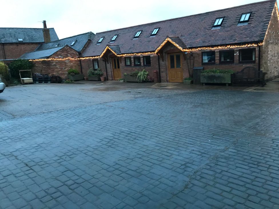 A building with outdoor lighting and a parking area