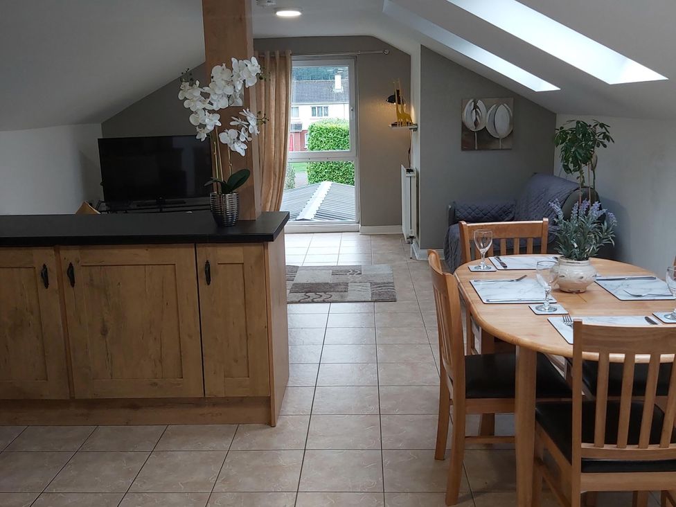 A living room with a dining area and a television at the property in unspecified location