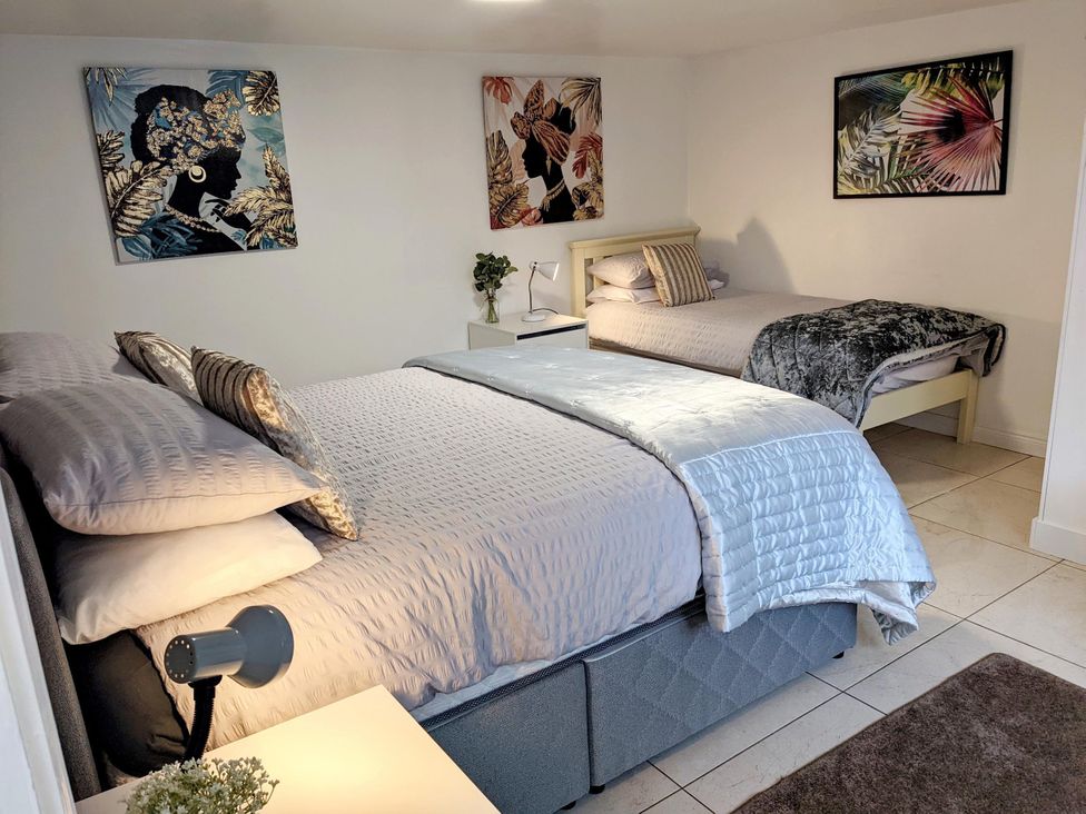A bedroom with two beds and wall art at the property