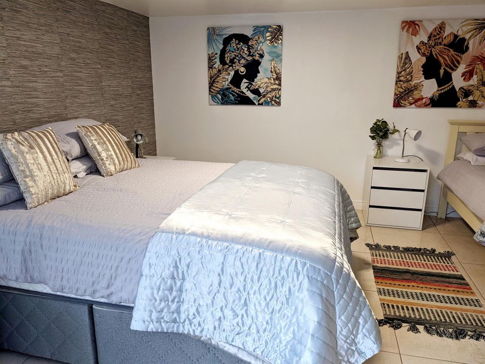 A bedroom with a bed and bedside table at The Old Barn in Manchester