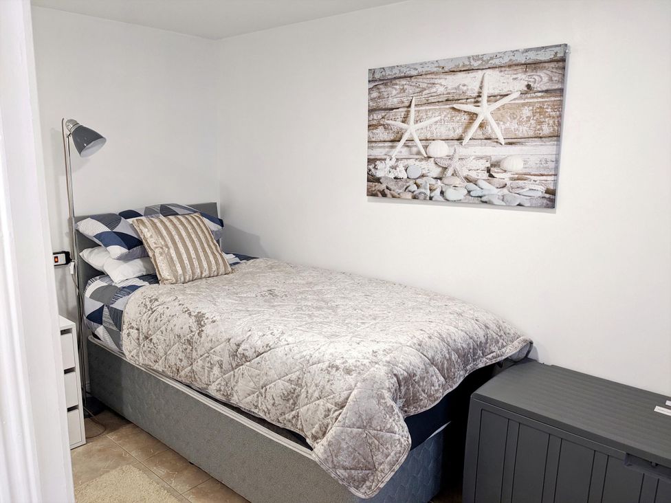 A bedroom with a bed and lamp at The Old Barn in Manchester