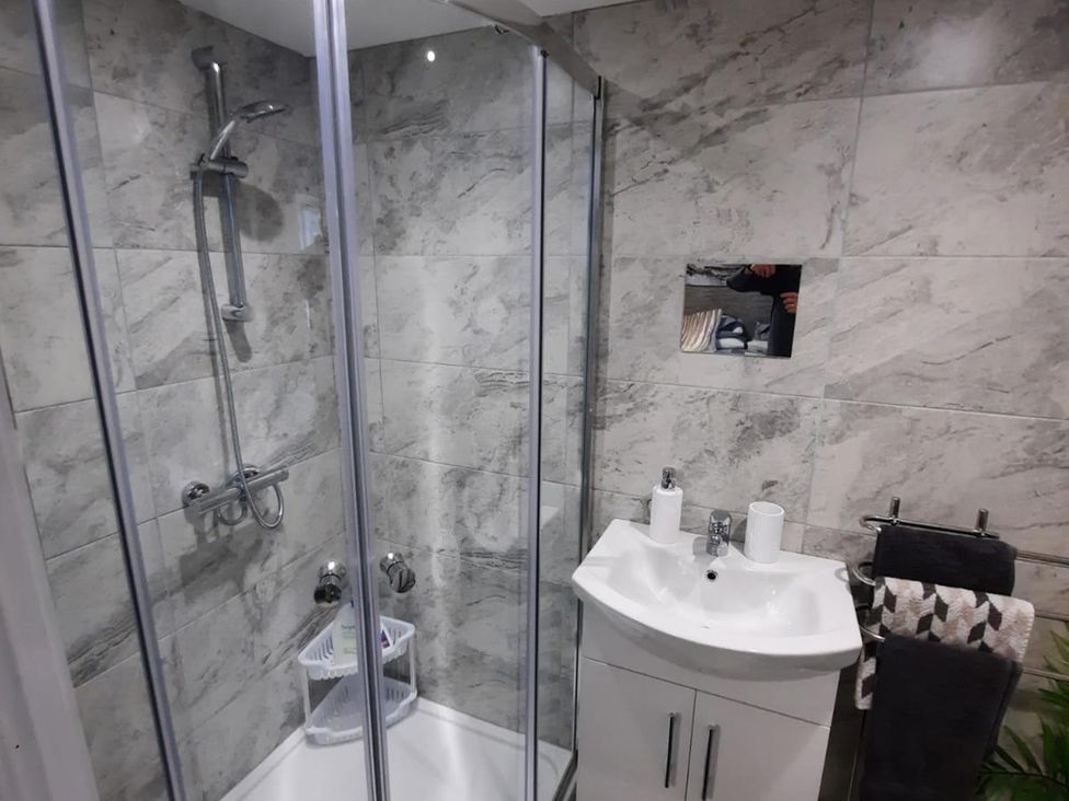 A bathroom with a shower and sink at the property