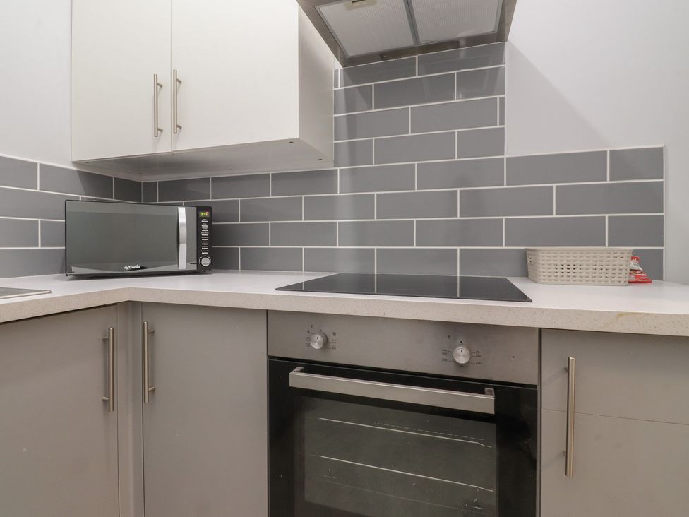 A kitchen with a microwave and an oven at Luxury Winter Gardens Apartment 1 Blackpool