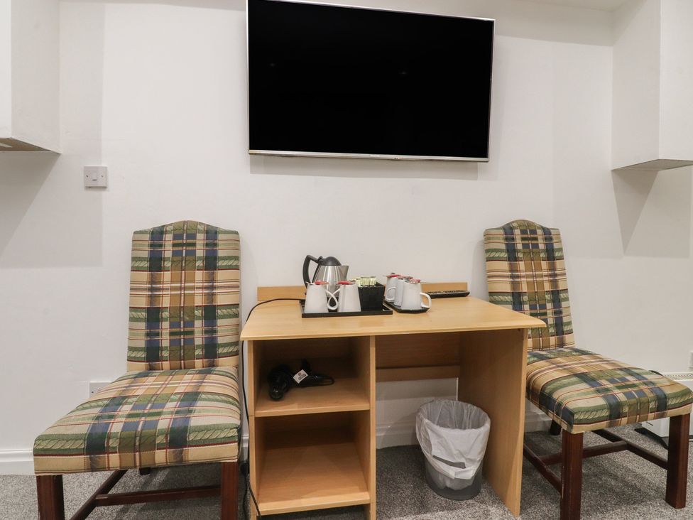 A dining area with a table and chairs at Luxury Winter Gardens Apartment 1 Blackpool