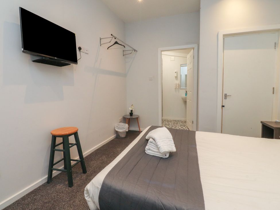 A bedroom with a bed and a television at Luxury Winter Gardens Apartment 1 Blackpool