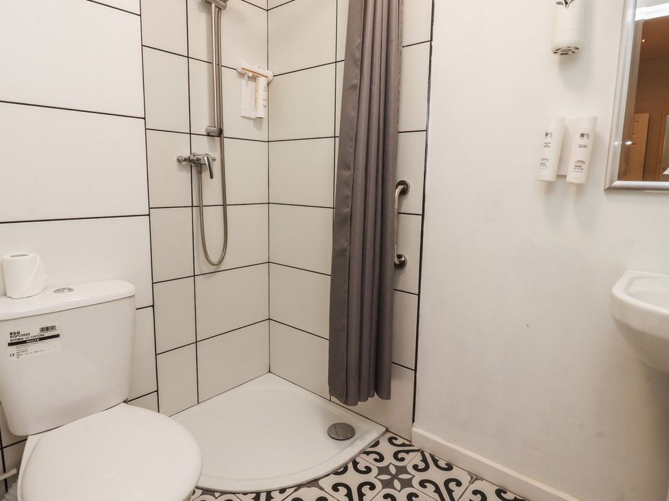 A bathroom with a toilet, shower, and sink at Luxury Winter Gardens Apartment 1, Blackpool