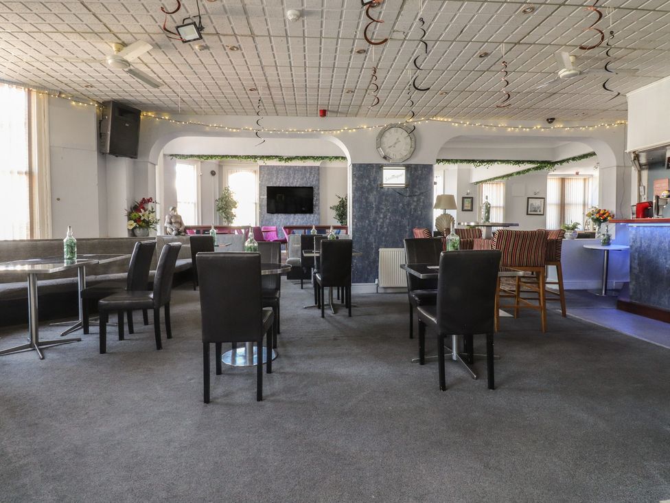 A lounge with seating and tables at Luxury Winter Gardens Apartment 1 Blackpool