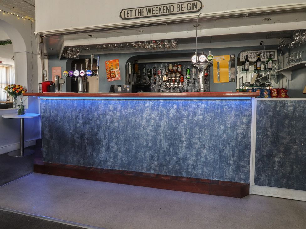 A bar area with a counter and beverages at Luxury Winter Gardens Apartment 1 Blackpool