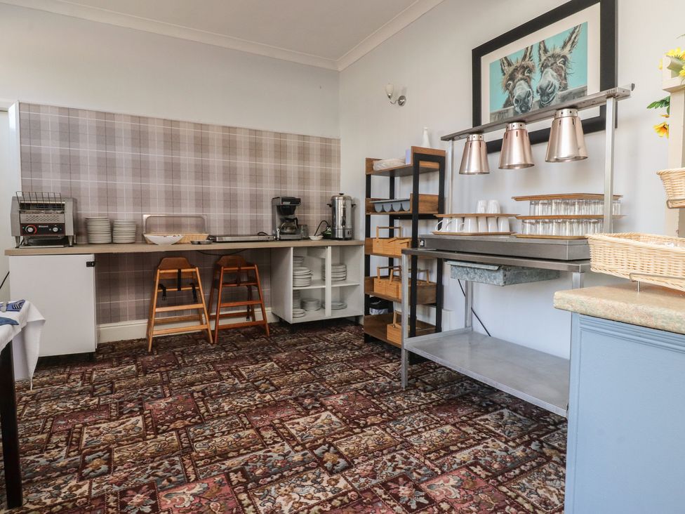 A kitchen with shelves and coffee maker at Luxury Winter Gardens Apartment 1 in Blackpool