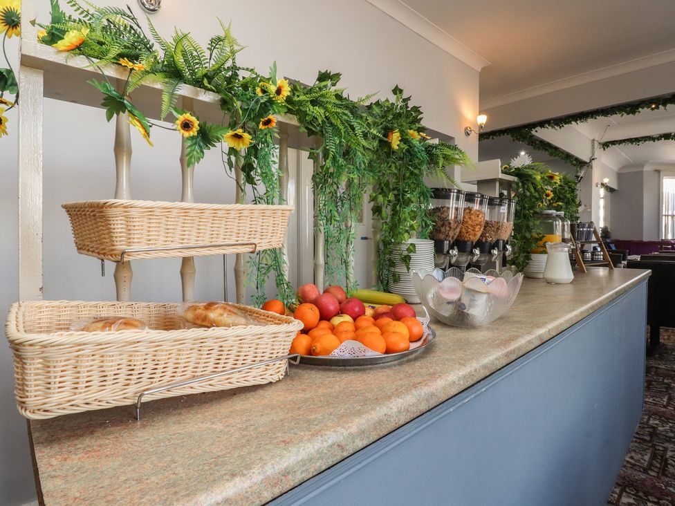 A breakfast area with baskets of bread and fruit at Luxury Winter Gardens Apartment 1 Blackpool