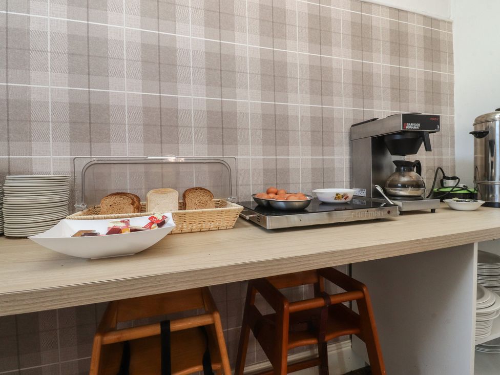 A kitchen counter with a coffee machine and bread at Luxury Winter Gardens Apartment 1, Blackpool