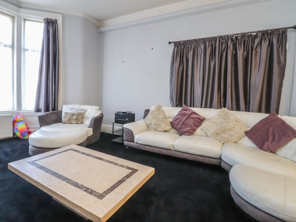 A living room with a sofa and coffee table at Luxury Winter Gardens Apartment 2 in Blackpool
