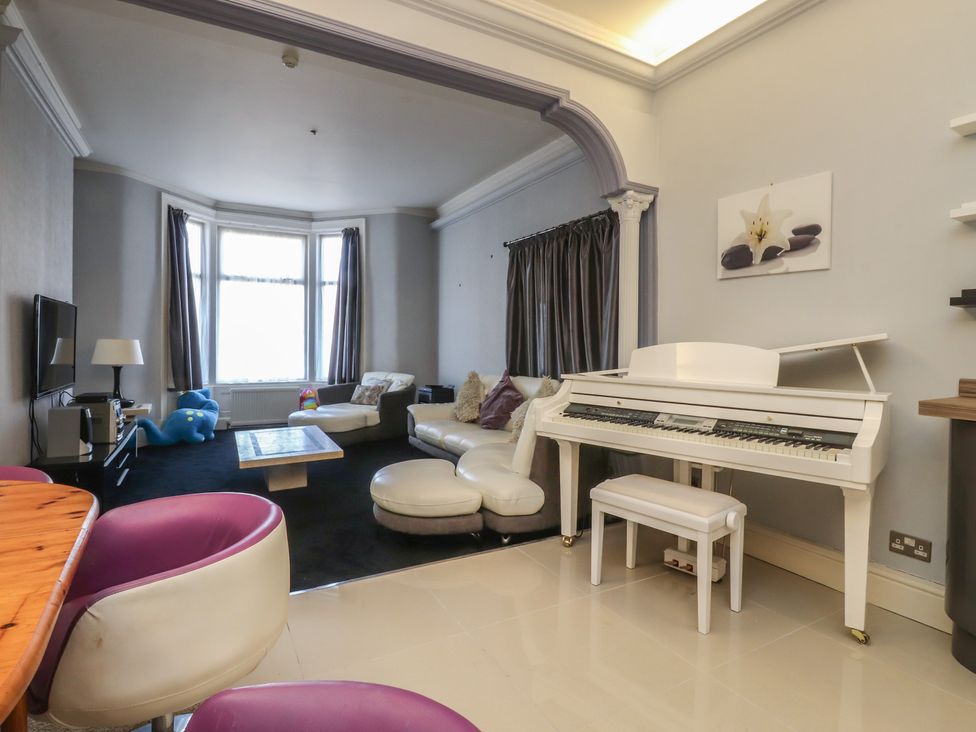A living room with a piano and sofa at Luxury Winter Gardens Apartment 2, Blackpool