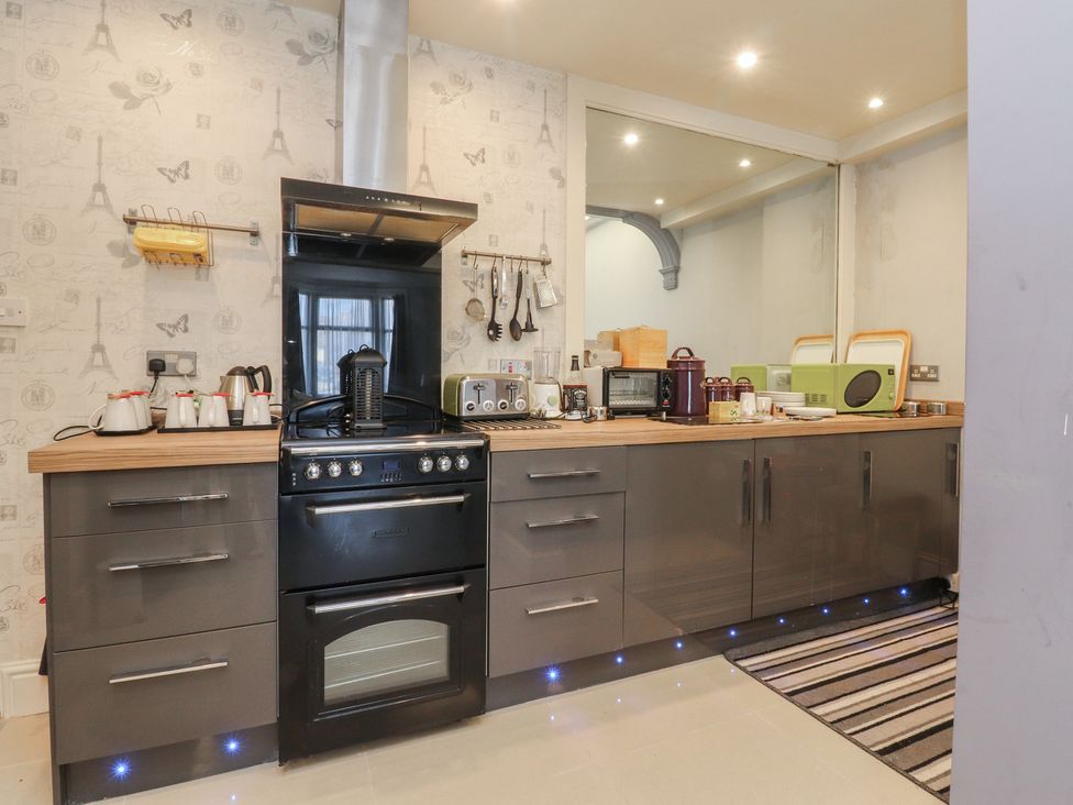 A kitchen with appliances and utensils at Luxury Winter Gardens Apartment 2 in Blackpool