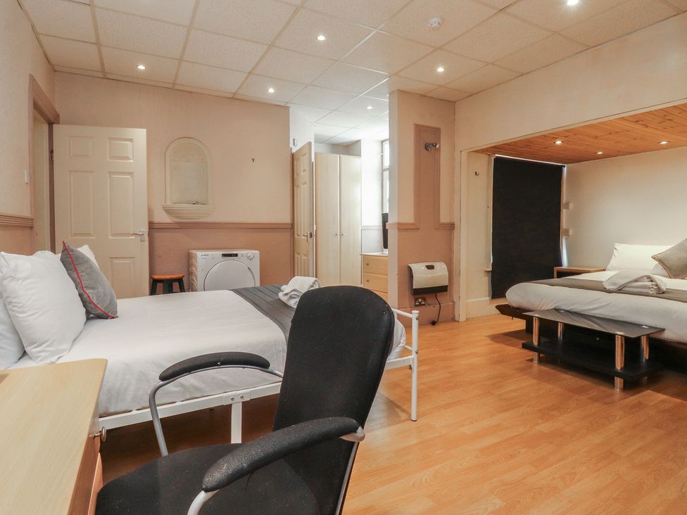 A bedroom with a bed and a desk at Luxury Winter Gardens Apartment 2 Blackpool