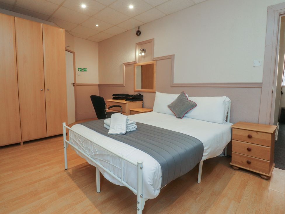 A bedroom with a bed and wardrobe at Luxury Winter Gardens Apartment 2 in Blackpool