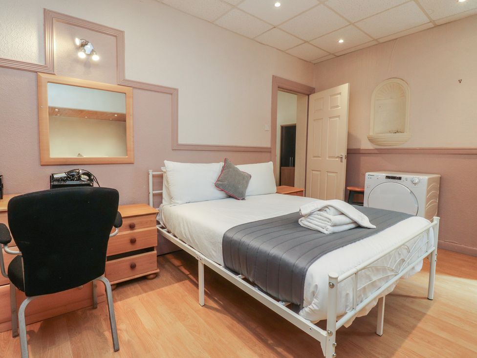 A bedroom with a bed and desk at Luxury Winter Gardens Apartment 2, Blackpool