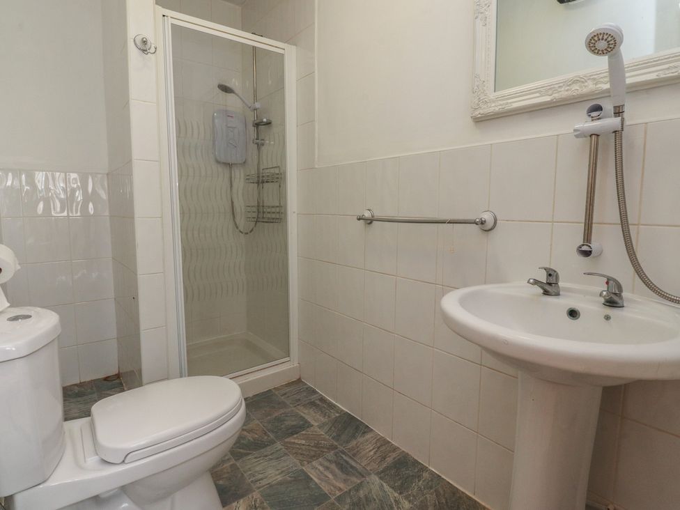 A bathroom with toilet, shower, and sink at Luxury Winter Gardens Apartment 2 Blackpool