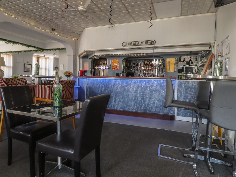 A bar area with seating and a counter at Luxury Winter Gardens Apartment 2 in Blackpool