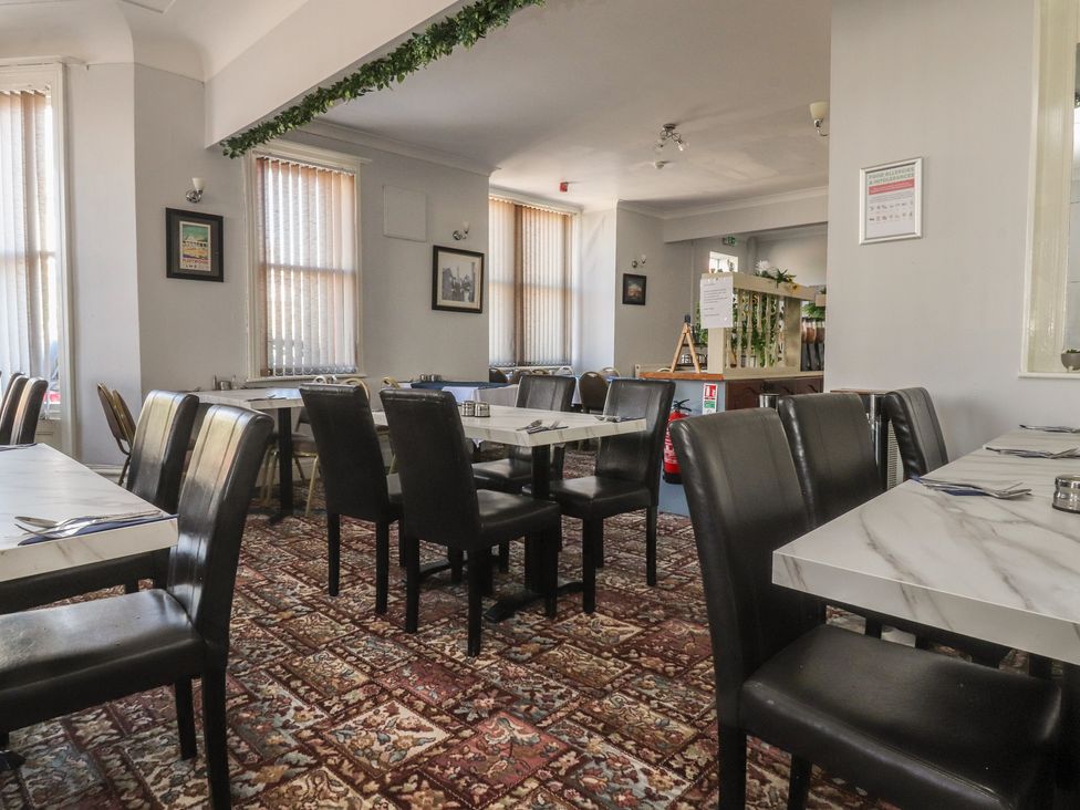 A dining room with tables and chairs at Luxury Winter Gardens Apartment 2 Blackpool