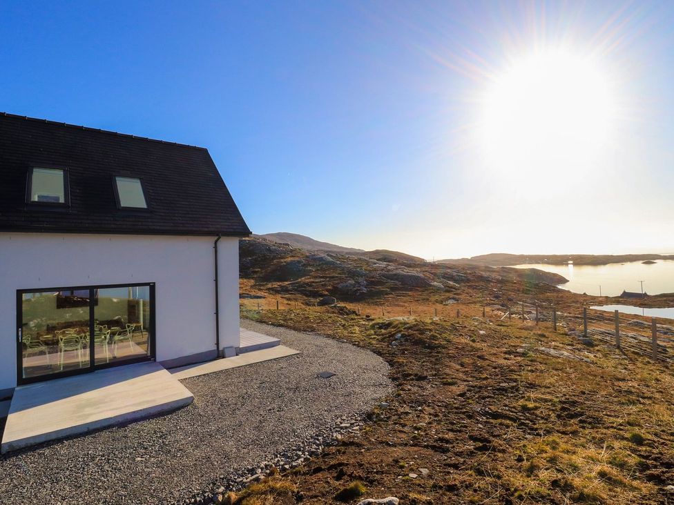 A house with a view of the water and landscape at 8B Carrigreich Isle of Harris