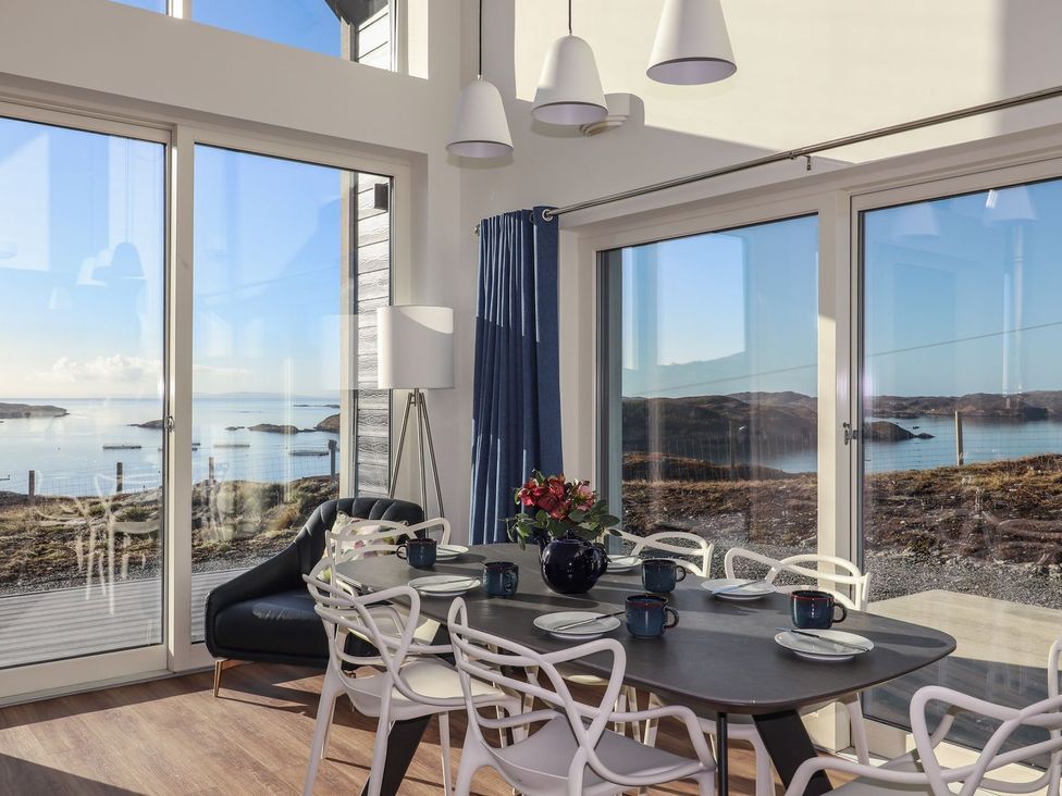 A dining room with a table and chairs at 8B Carrigreich Isle of Harris