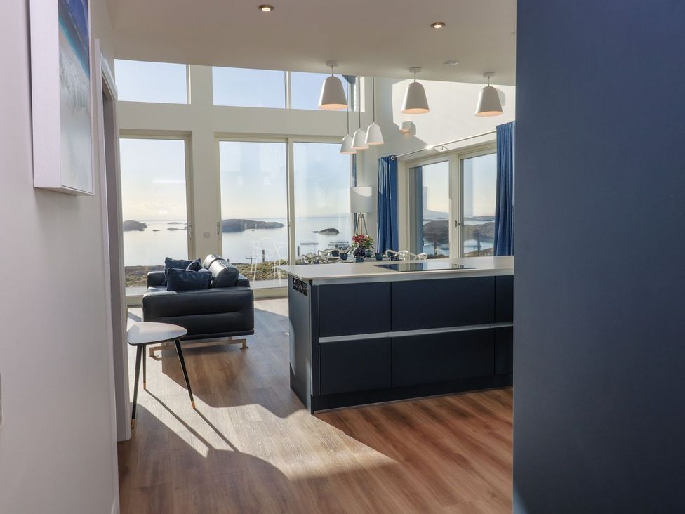 A kitchen with a sofa and window overlooking water at 8B Carrigreich Isle of Harris