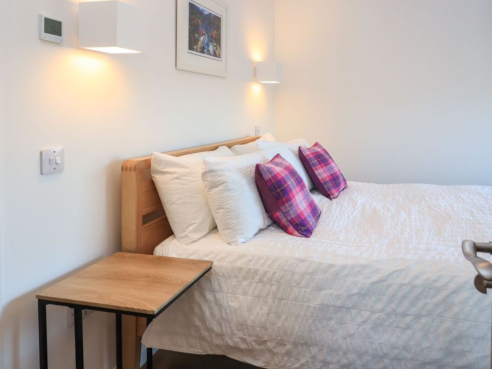A bedroom with a bed and nightstand at 8B Carrigreich Isle of Harris