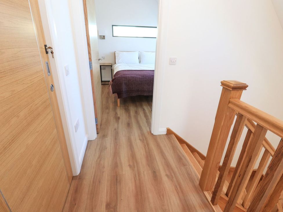 A bedroom with a bed and nightstand at 8B Carrigreich Isle of Harris