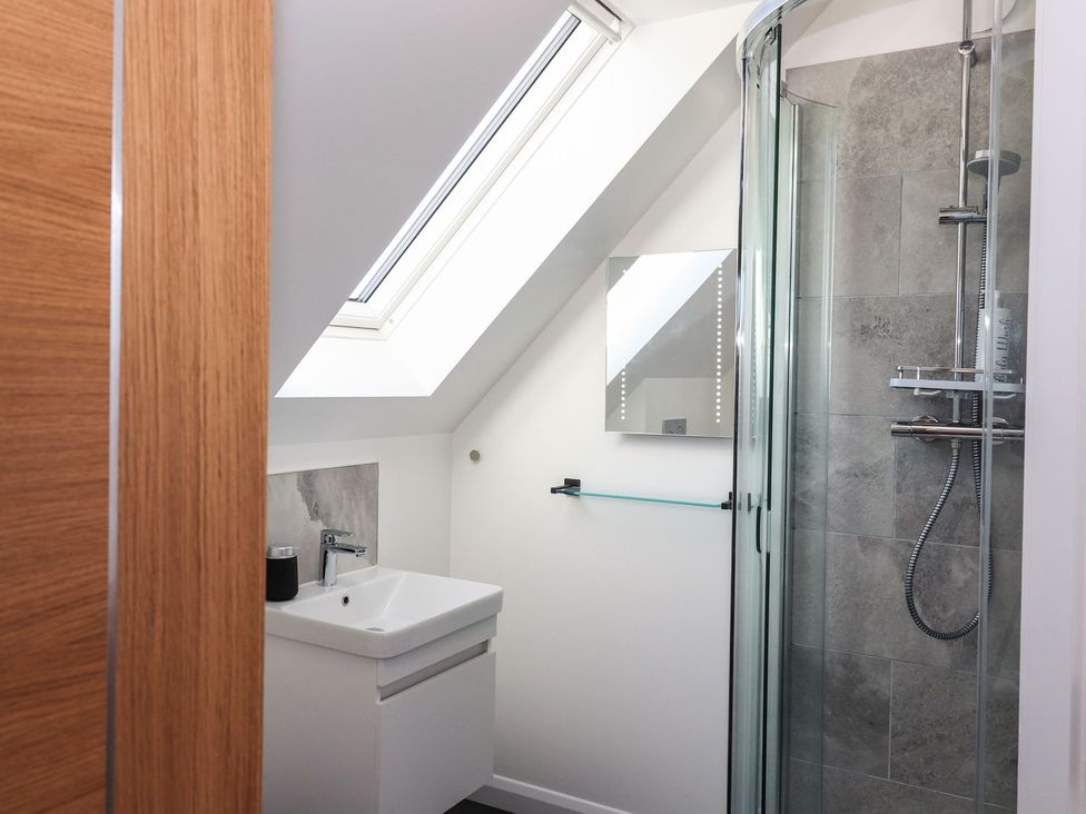 A bathroom with a sink and shower at 8B Carrigreich Isle of Harris