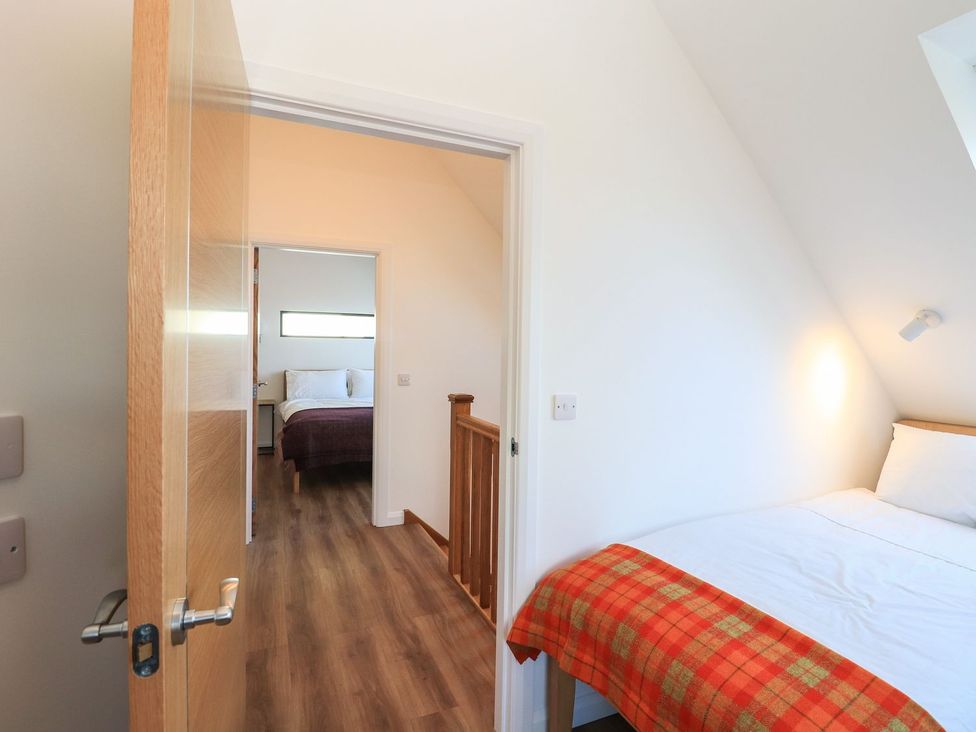 A bedroom with a bed and doorway at 8B Carrigreich Isle of Harris