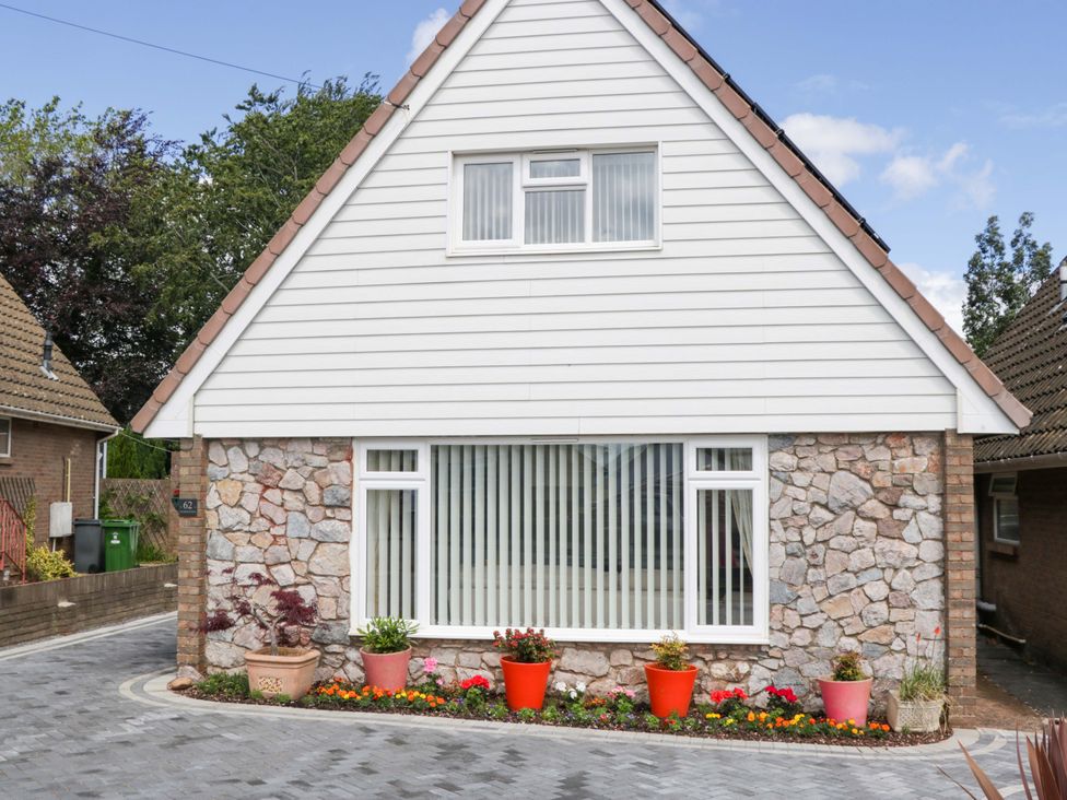 A house with a stone wall and front garden at Halsdon Avenue Exmouth