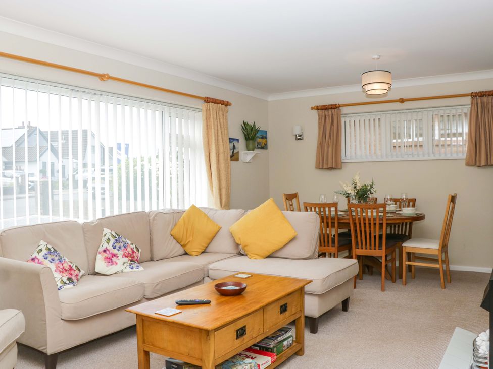 A living room with sofa and dining area at Halsdon Avenue in Exmouth