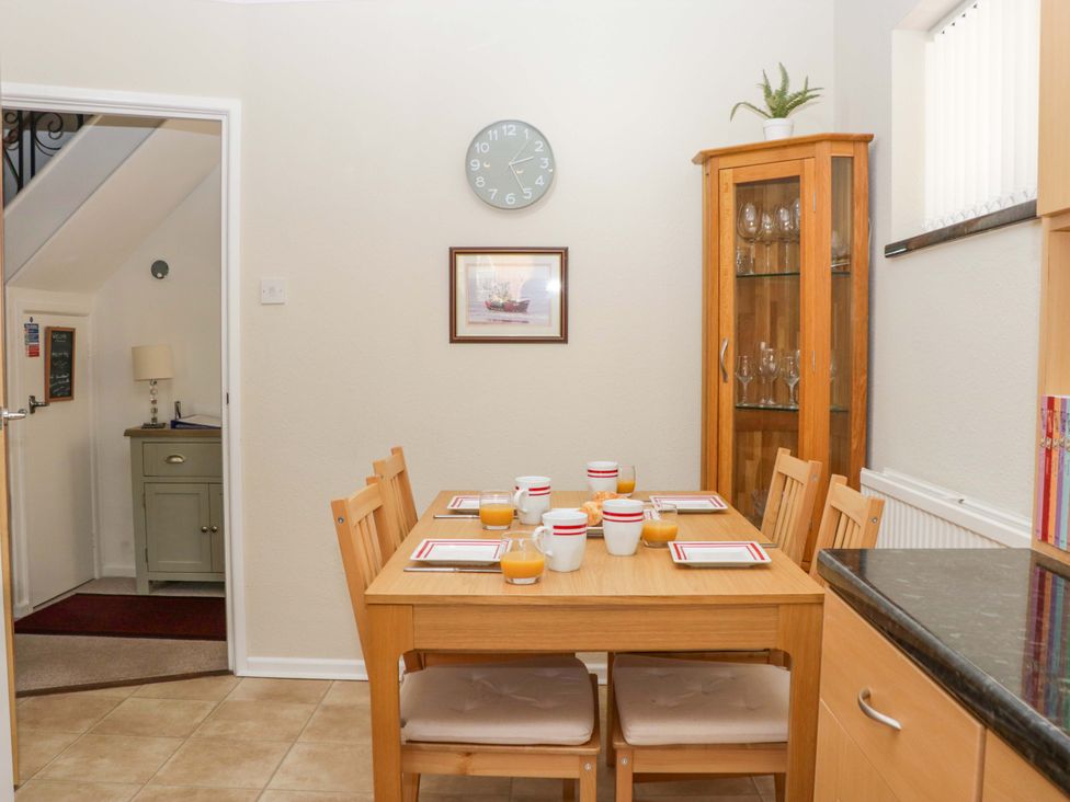 A dining room with a table set for breakfast at Halsdon Avenue in Exmouth